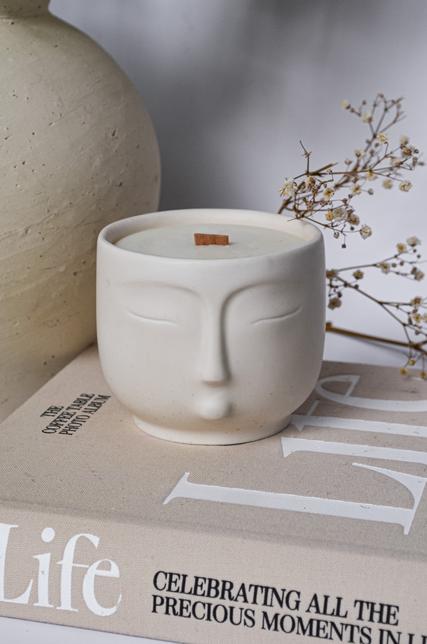 relaxing spa off white scented candle jar with face on it