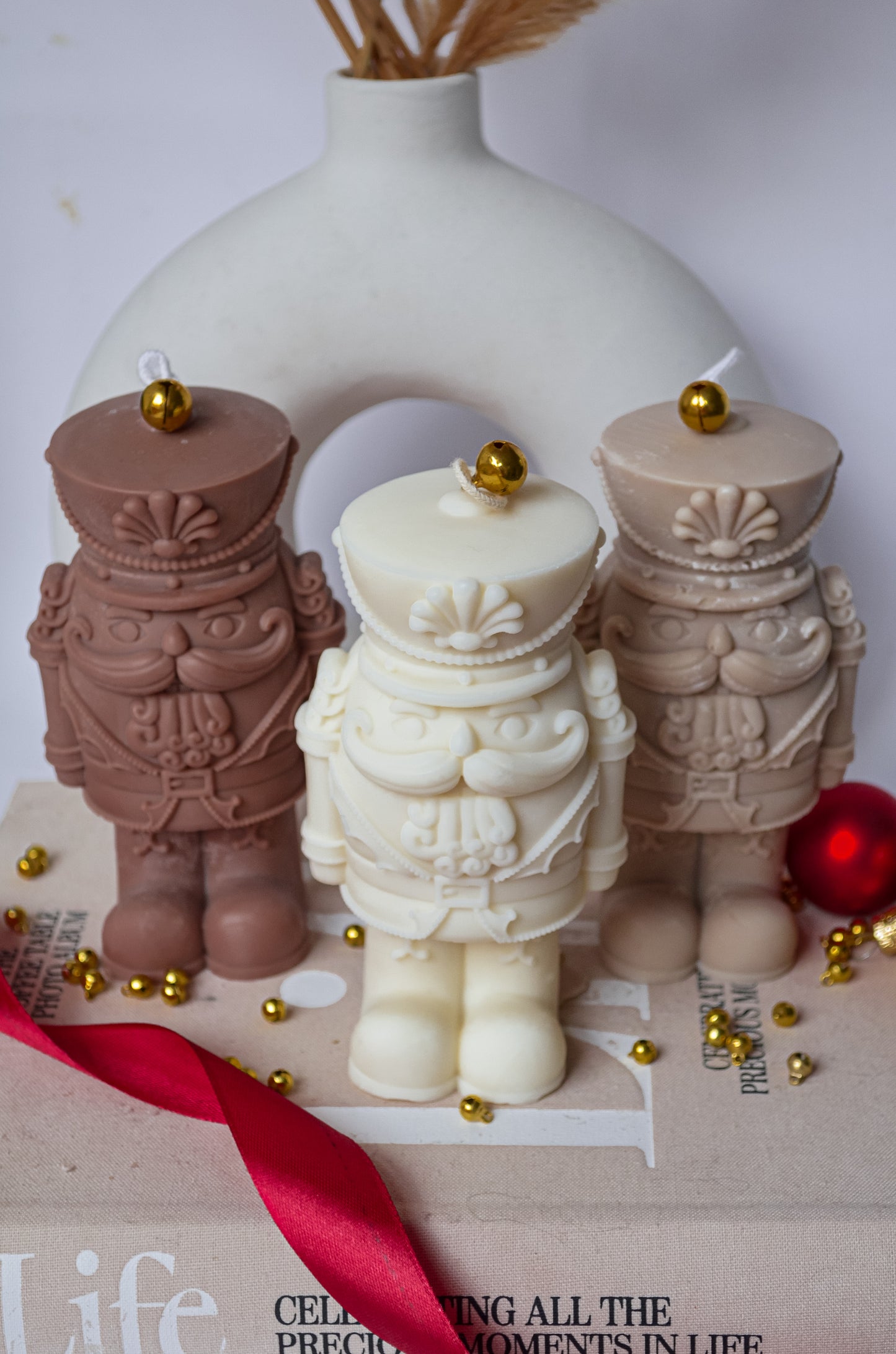 Beige white and many coloured nut cracker candle